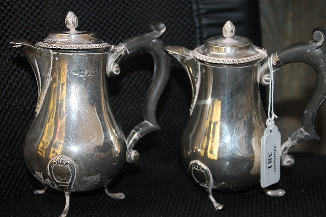 Appraisal: A PAIR OF SMALL SILVER CHOCOLATE POTS each with hardwood