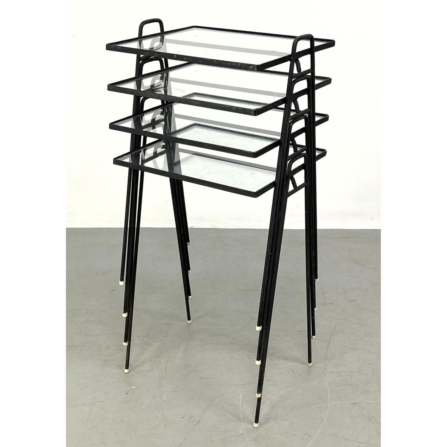 Appraisal: Set Stacking Black Iron and Glass Side Tables Modernist design