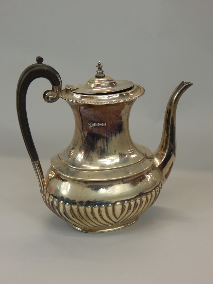 Appraisal: An Edwardian silver teapot with an ebonised handle and part