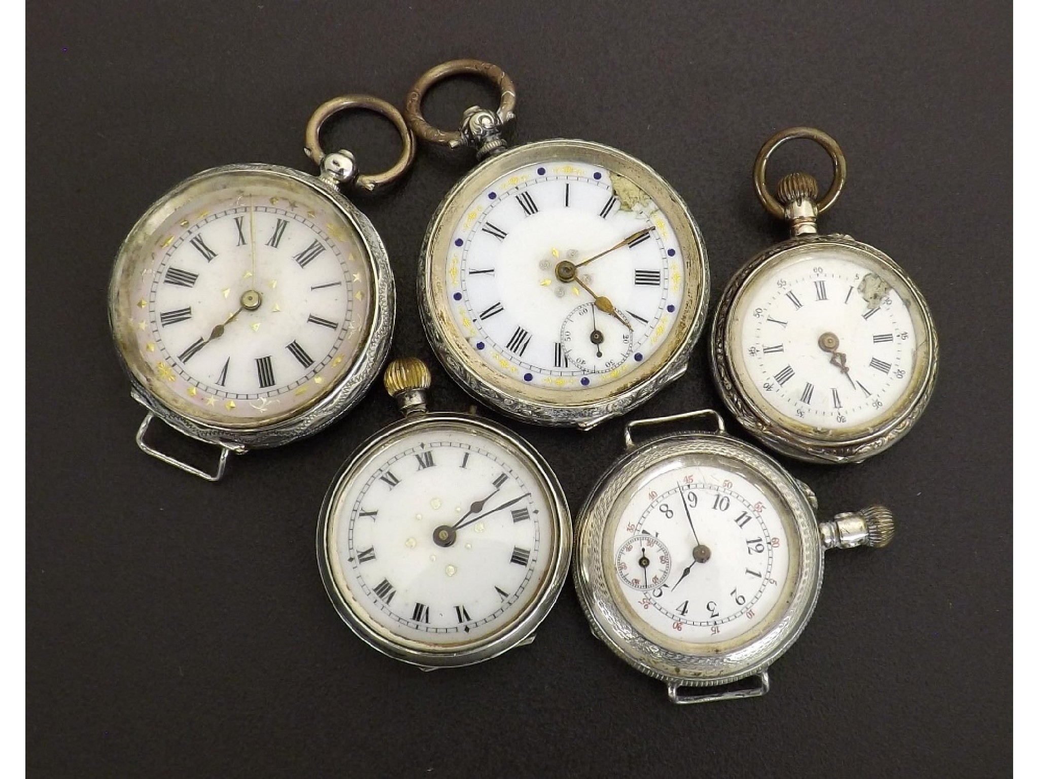 Appraisal: Four silver engraved cylinder fob watches together with a cylinder