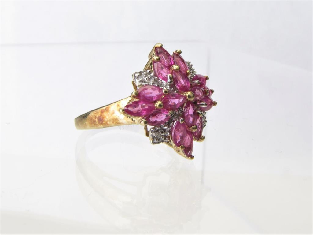 Appraisal: A K yellow gold cluster ring with sixteen marquis rubies