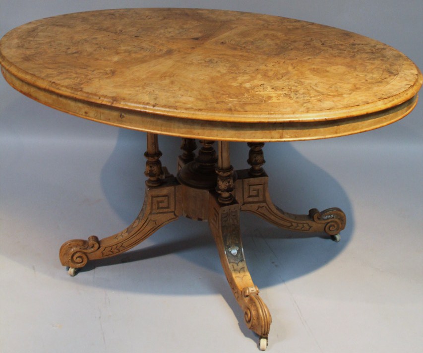 Appraisal: A thC walnut loo table the oval top inlaid with