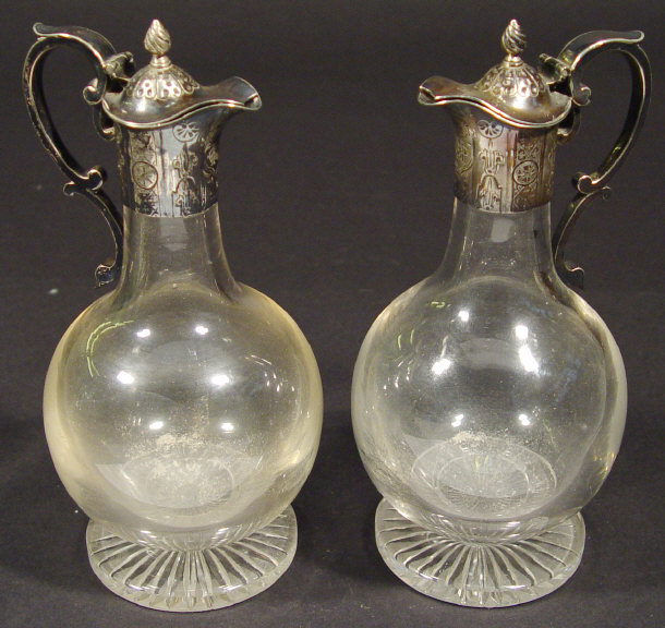 Appraisal: Pair of cut glass ewers with chased silver plated mounts