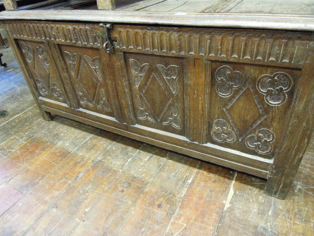 Appraisal: A Georgian oak coffer with panelled frame and carved foliate