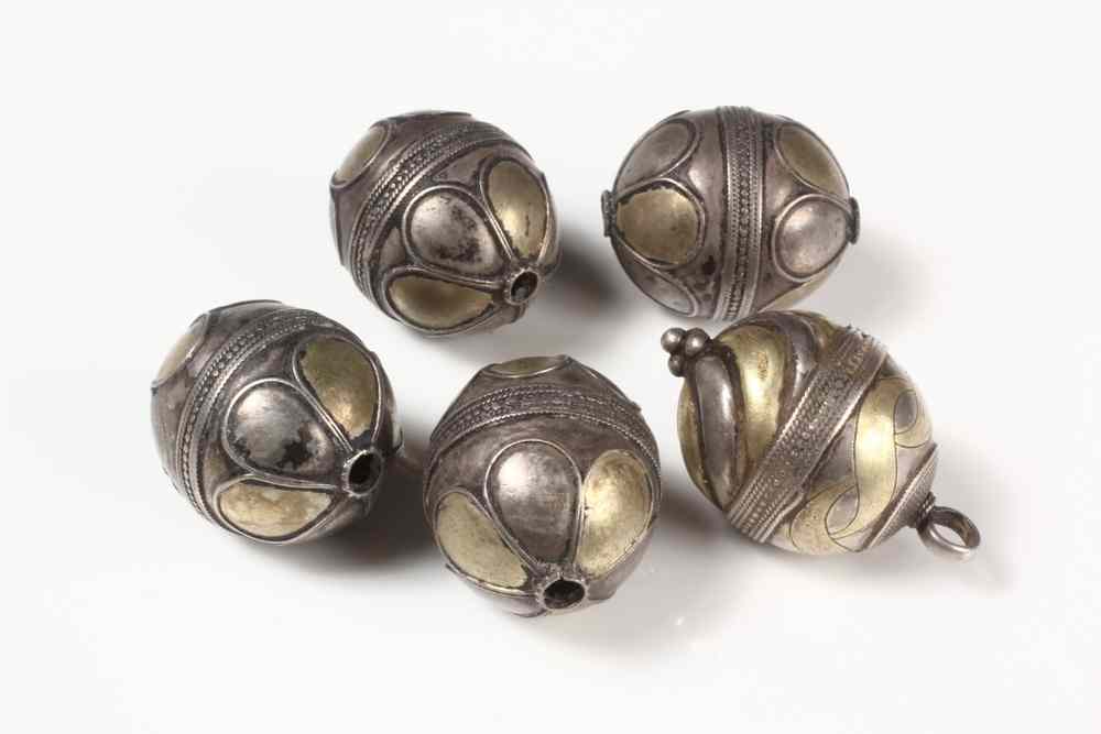 Appraisal: FIVE ISLAMIC BRASS AND SILVER BEADS Mughal India th Century