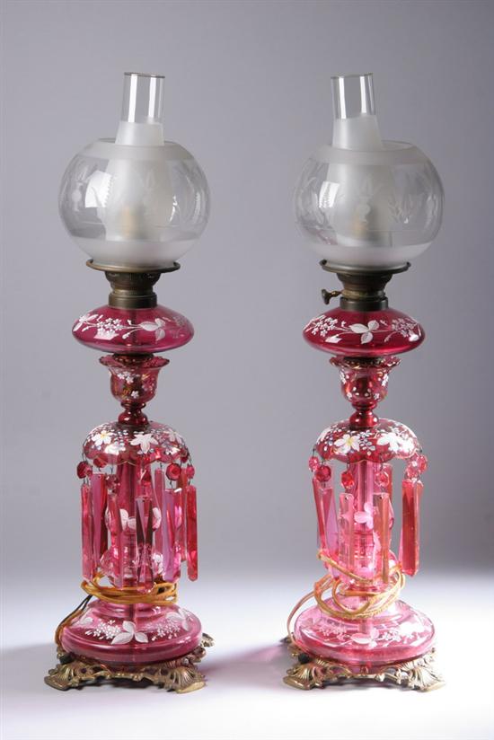 Appraisal: PAIR CRANBERRY GLASS LUSTER LAMPS Matador Brenner With enamelled floral