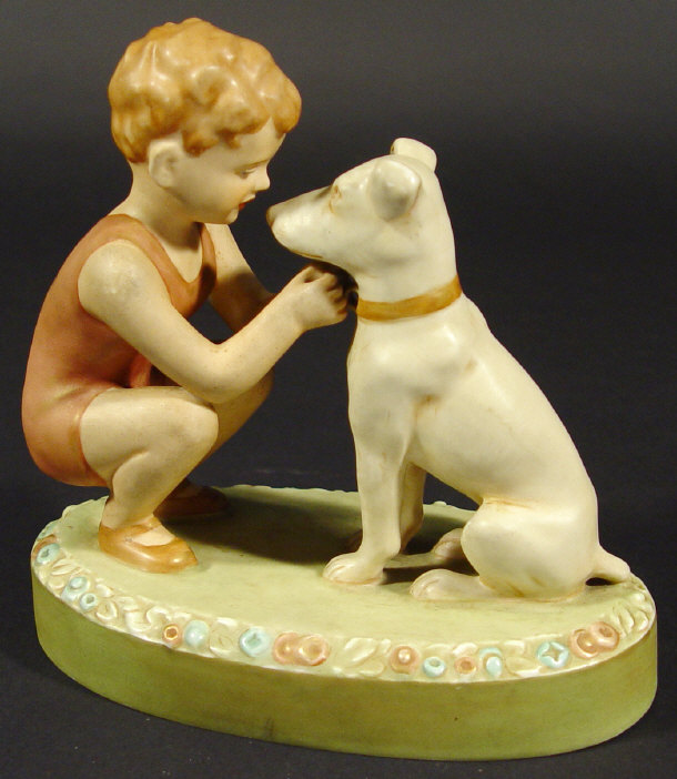 Appraisal: Royal Dux porcelain young boy and dog on a floral