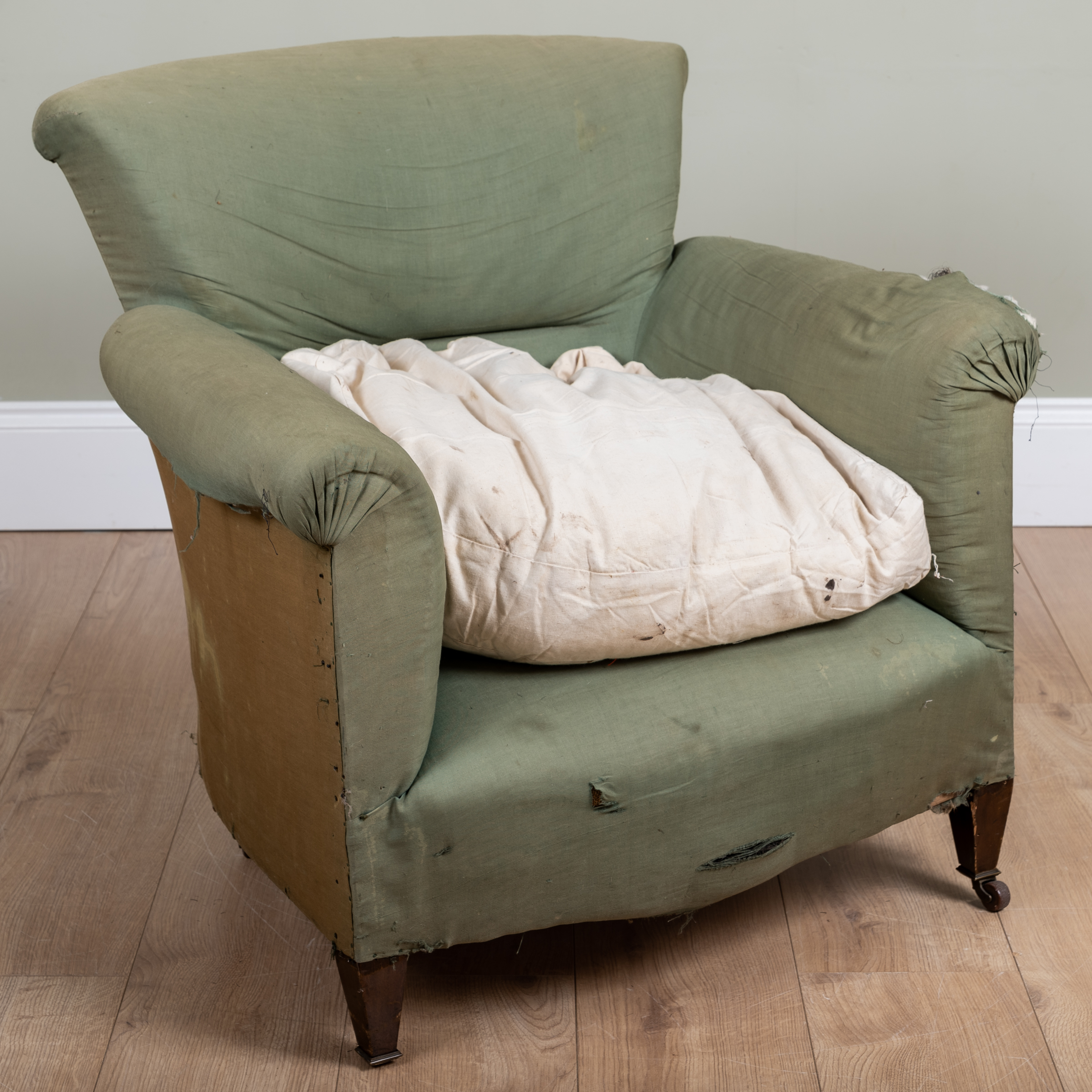 Appraisal: A small green upholstered tub armchair with scrolling arms and