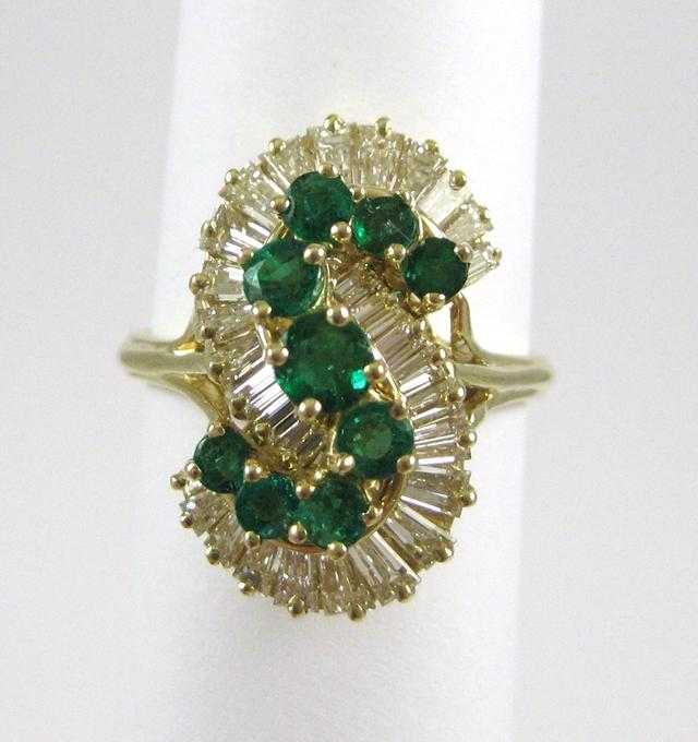 Appraisal: EMERALD DIAMOND AND FOURTEEN KARAT GOLD RING with tapered baguette