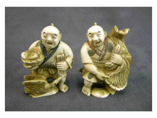 Appraisal: Two lightly stained ivory netsuke one depicting a man with