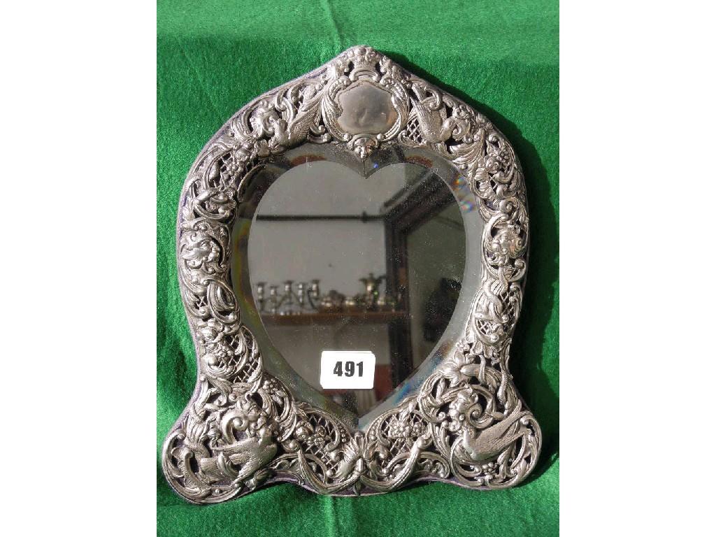 Appraisal: A silver dressing table mirror with bevelled heart-shaped mirror within