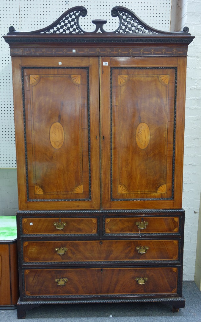 Appraisal: A George III inlaid mahogany linen press the pierced fret