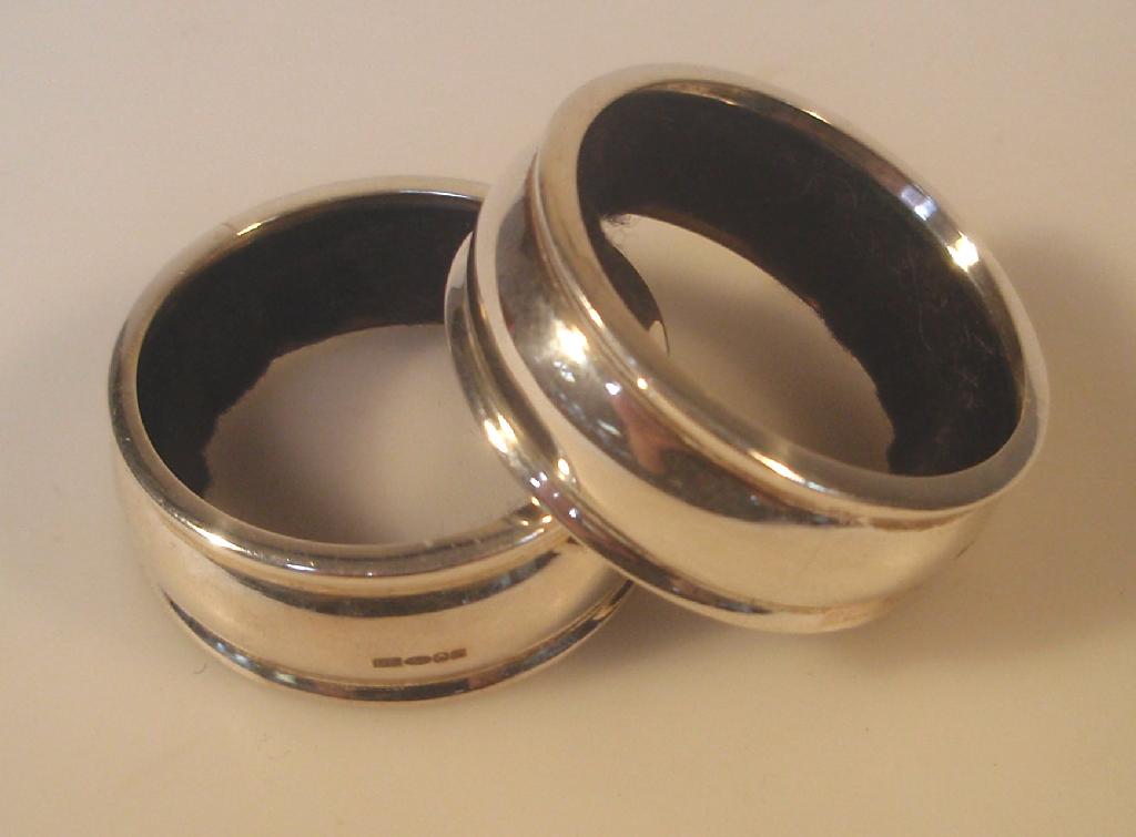 Appraisal: A pair of modern silver wine bottle neck drip rings