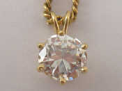 Appraisal: A diamond solitaire pendant on a carat gold chain the