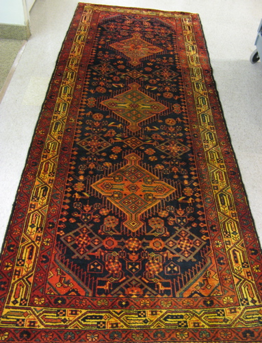 Appraisal: PERSIAN TRIBAL AREA RUG three geometric medallion and stylized flowers