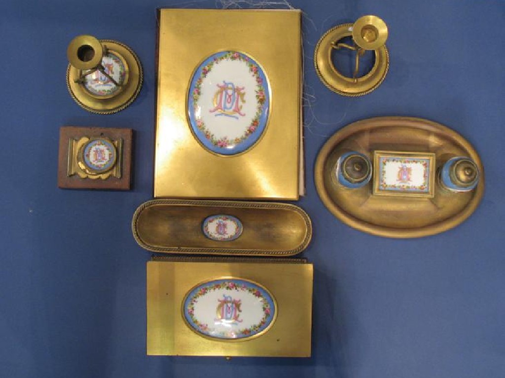 Appraisal: A VICTORIAN GILT METAL DESK SET comprising blotter inkwells candlestick