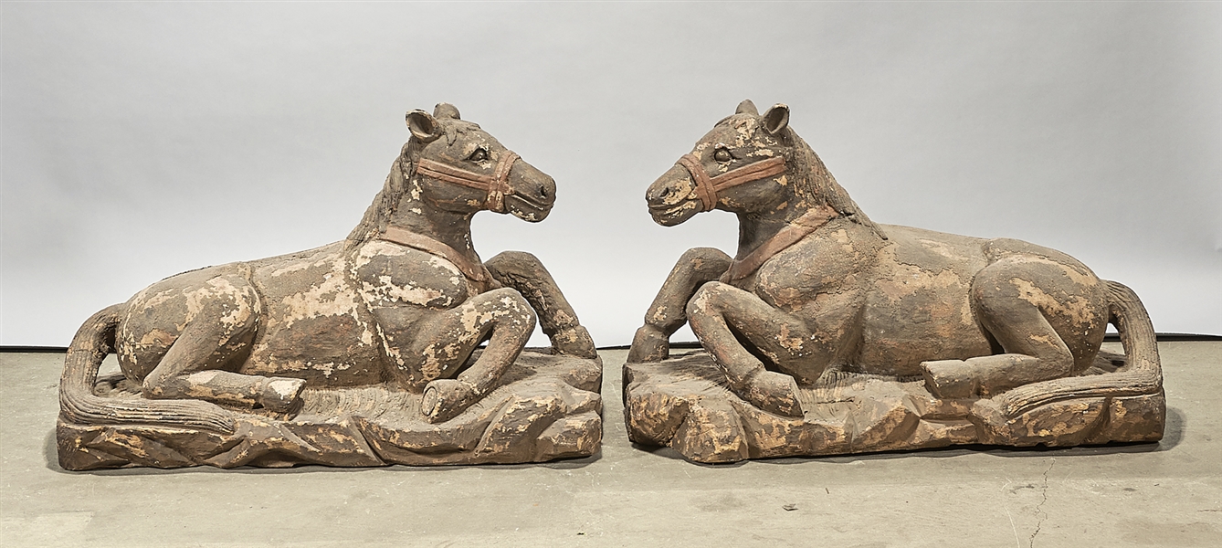 Appraisal: Pair of Chinese carved wood seated horses with pigment remnants