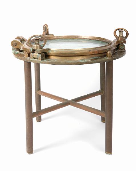 Appraisal: A brass coffee table made of ship's porthole height in