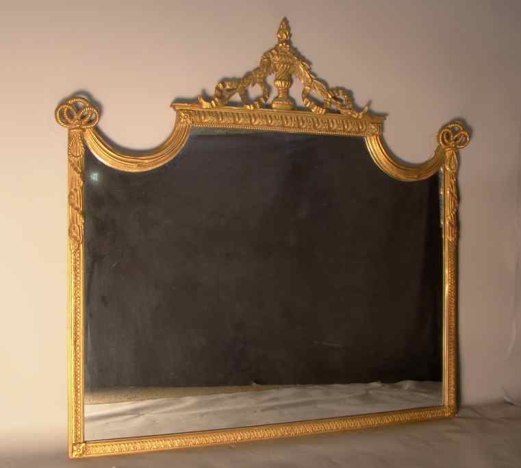 Appraisal: VICTORIAN STYLE GILTWOOD MIRROR With urnform cresting issuing fruit and