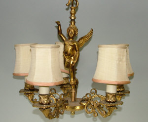 Appraisal: A pair of gilt metal five branch winged putto chandeliers