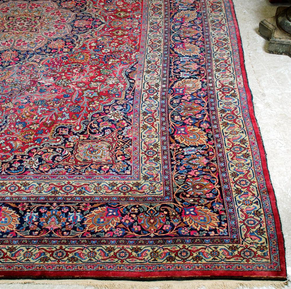 Appraisal: A KASHAN CARPET the red floral field centred by a