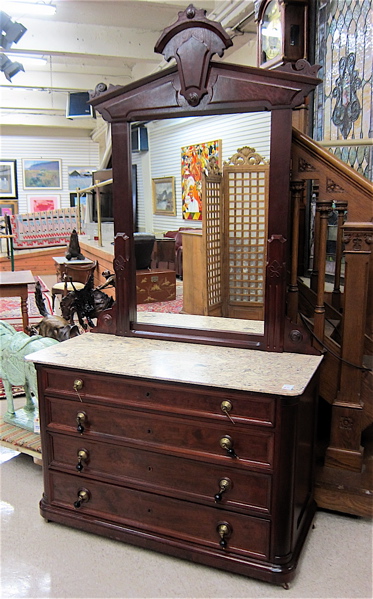 Appraisal: A VICTORIAN WALNUT DRESSER WITH MIRROR American th century featuring