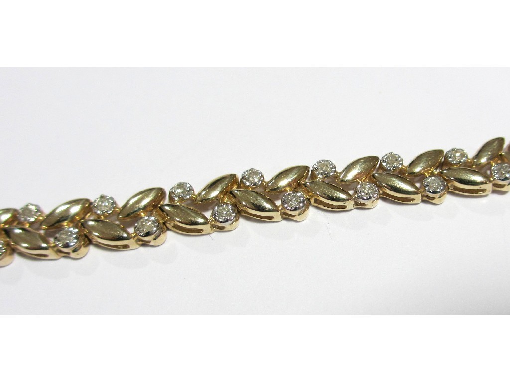 Appraisal: A nine carat gold diamond set chevron design bracelet with