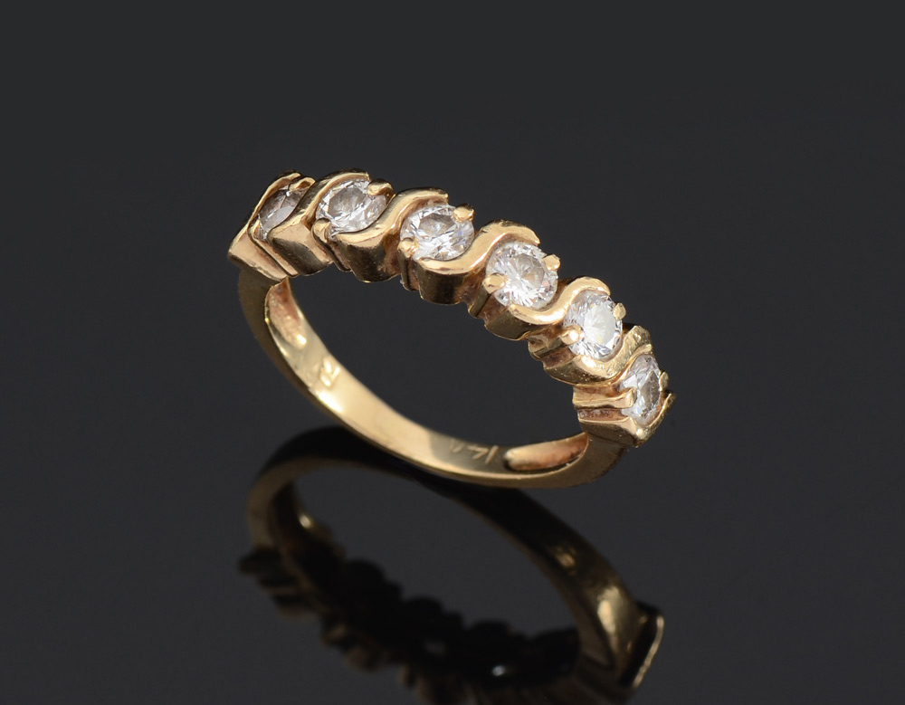 Appraisal: DIAMOND WEDDING BAND K yellow gold ring contains round brilliant