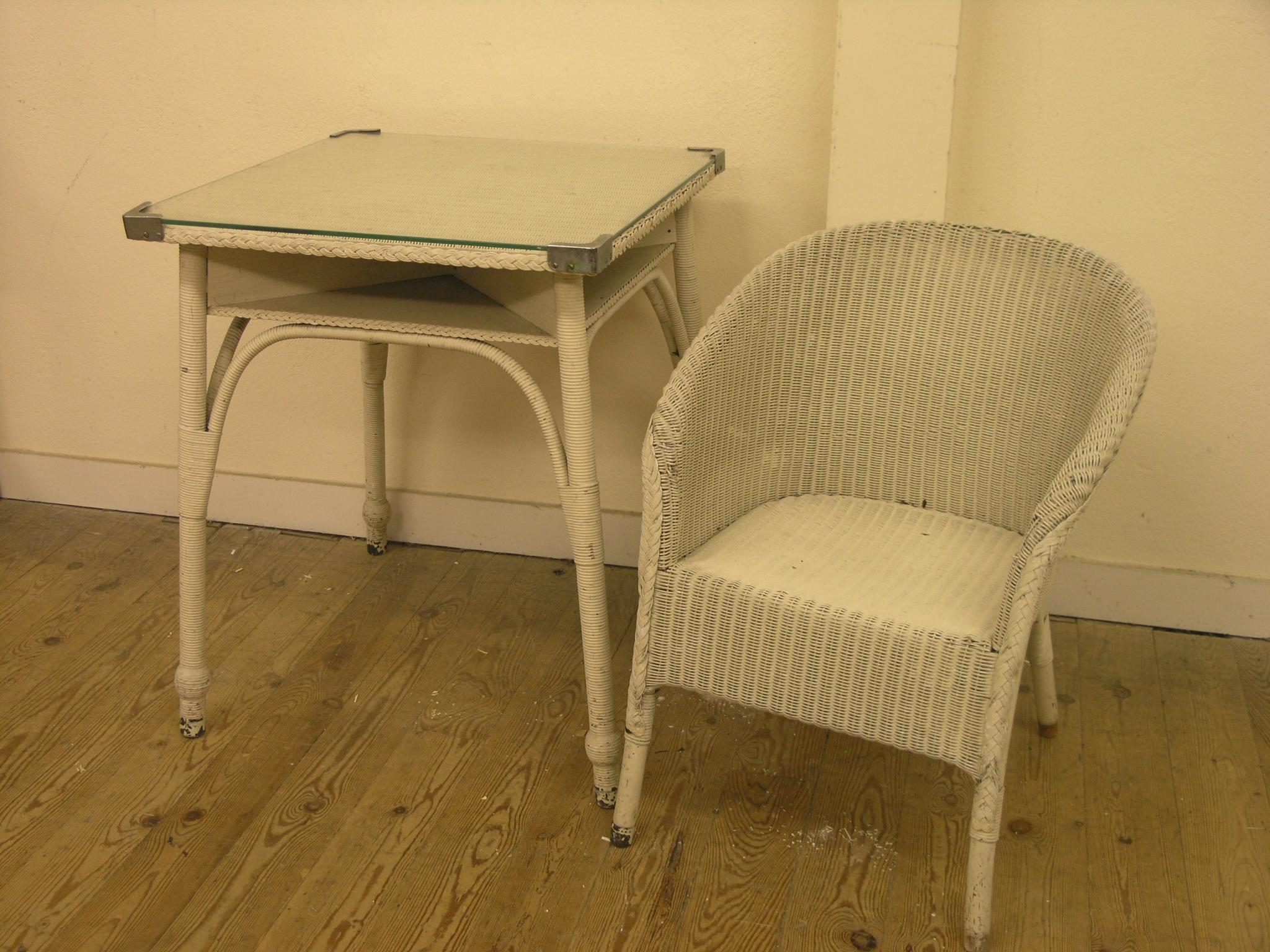 Appraisal: A Lloyd Loom cream-sprayed conservatory table ft a matchng armchair