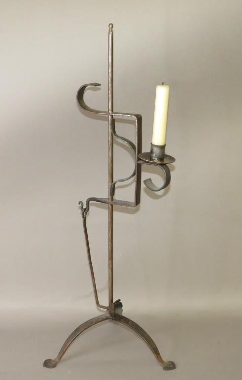 Appraisal: FOLK ART HAND FORGED FOOTED ADJUSTABLE CANDLE LAMPca late th