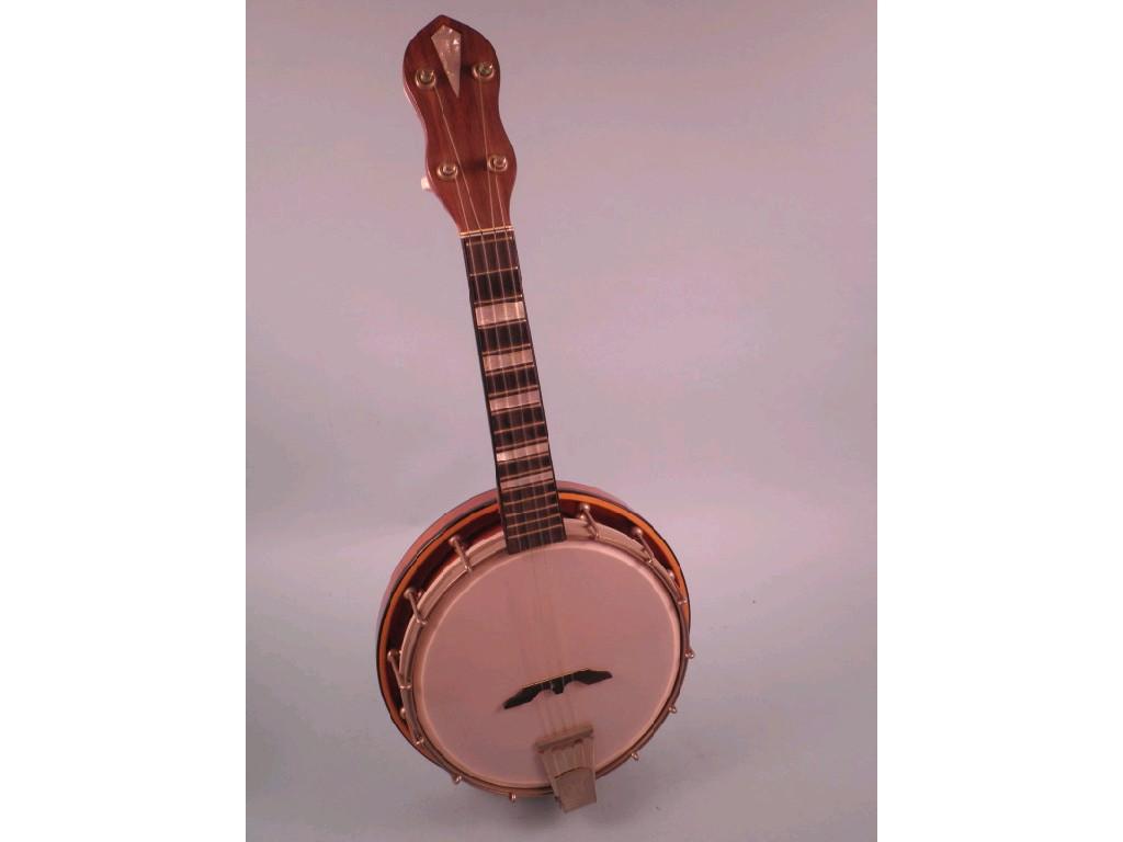 Appraisal: A mahogany and ebonised banjolele with simulated mother of pearl