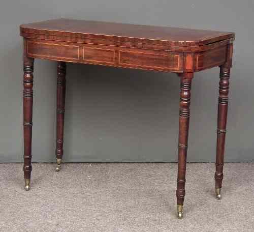 Appraisal: A George III mahogany D-shaped card table the folding baize