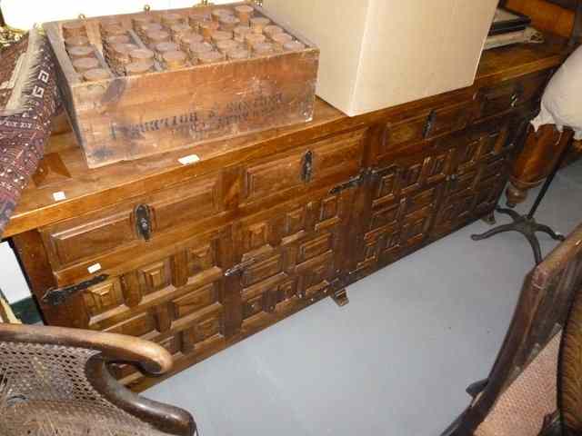 Appraisal: A STAINED WOODEN SIDEBOARD with four drawers over two pairs