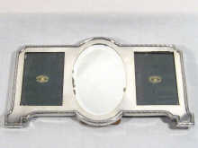 Appraisal: An English silver strut back double photograph frame with central