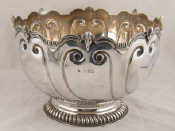 Appraisal: A silver punch bowl with gadrooned foot the rim embellished