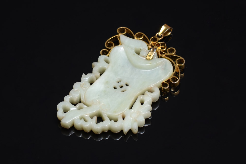 Appraisal: CHINESE CARVED STONE JADE PENDANT In the form of fruit