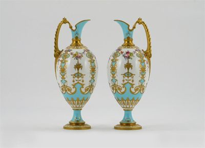 Appraisal: A good pair of Royal Crown Derby ewers painted by