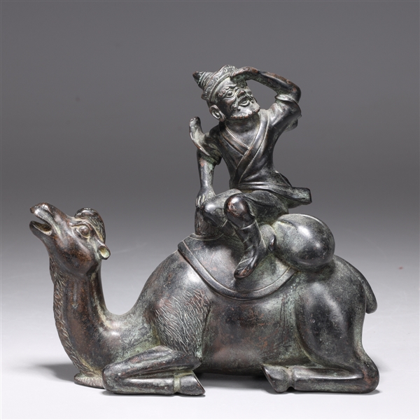 Appraisal: Chinese Tang sytle bronze figure seated on a recumbent camel