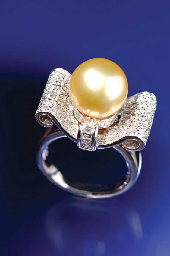 Appraisal: PEARL AND DIAMOND RING Large cultured gold color pearl of