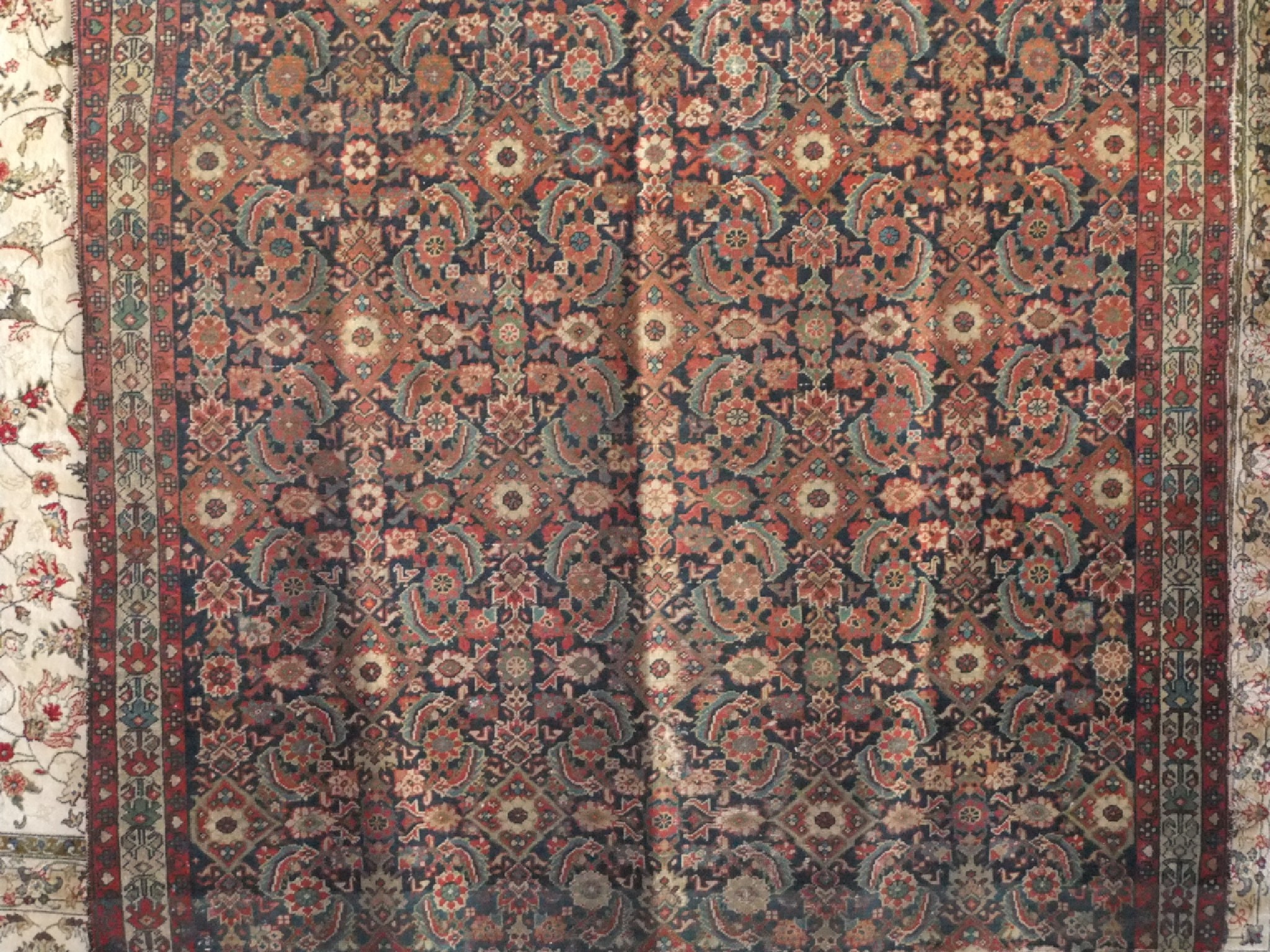 Appraisal: An old eastern wool carpet the blue ground interspersed with