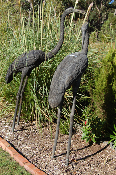 Appraisal: A PAIR OF CAST METAL STORKS