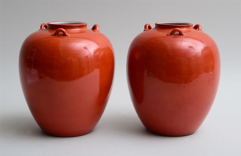 Appraisal: PAIR OF ASIAN STYLE ORANGE-GLAZED POTTERY VASES Each fitted with