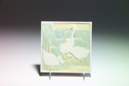 Appraisal: ROOKWOOD Trivet tile modeled with three white geese in a