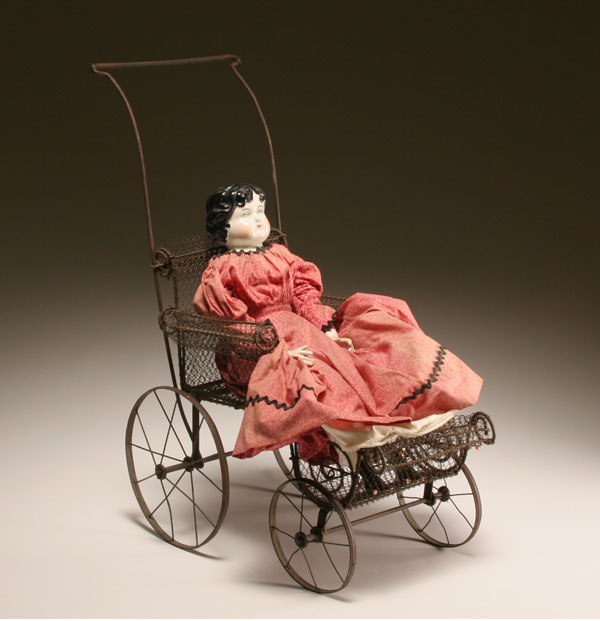 Appraisal: Antique China doll on Victorian wire mesh stroller carriage China