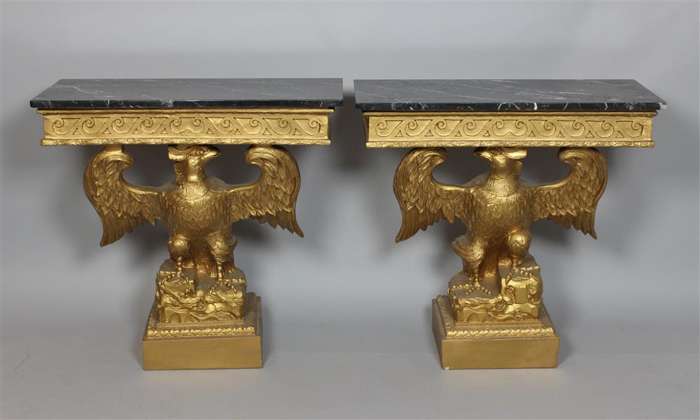 Appraisal: PAIR OF CARVED AND GILDED CONSOLE TABLES WITH BLACK MARBLE