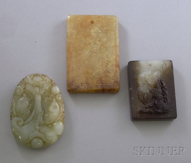 Appraisal: Three Carved Jade Pendants a green oval with fish a