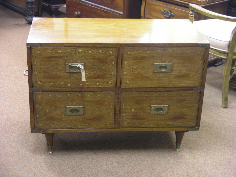 Appraisal: A teak military style chest of drawers inlaid with brass