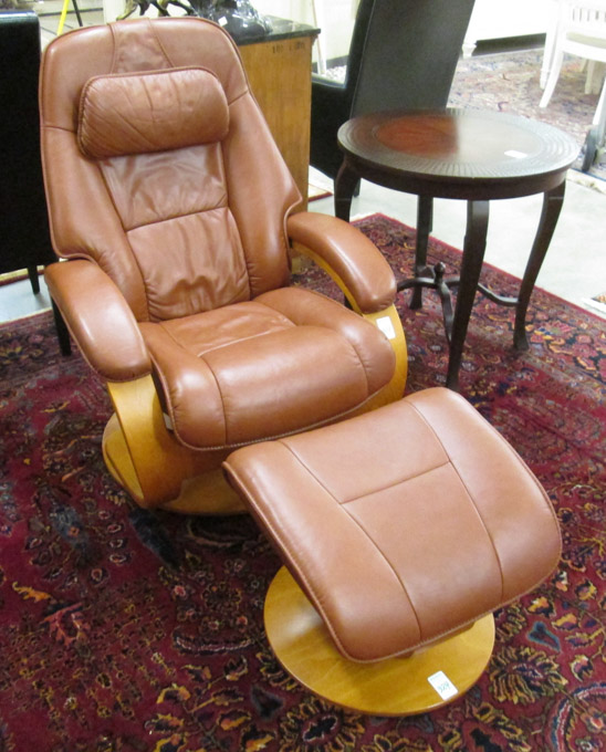 Appraisal: NORWEGIAN MODERN LEATHER SWIVEL RECLINER WITH MATCHING FOOTSTOOL Hjellegjerde Mobler