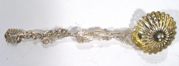 Appraisal: Ornate silver sugar sifting spoon with leaf and berry design