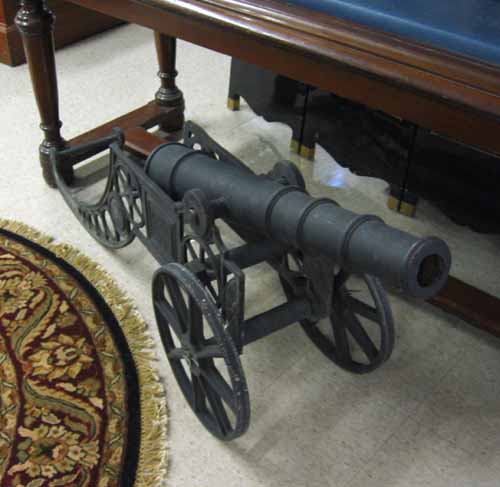 Appraisal: CAST IRON CANNON The tapering ringed barrel on a cast